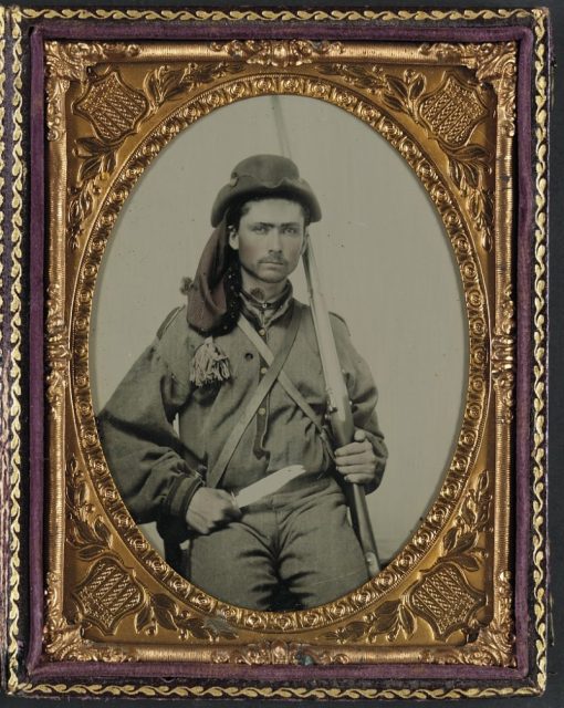 Unidentified soldier in Confederate infantry uniform with musket and Bowie knife.
