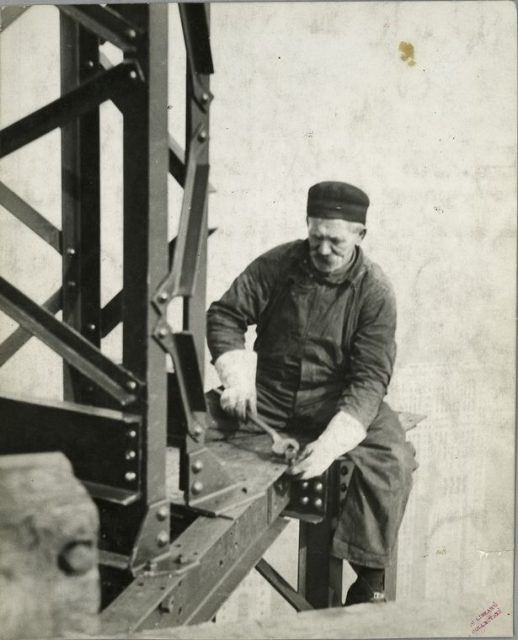 Worker attaching a bolt onto a beam.