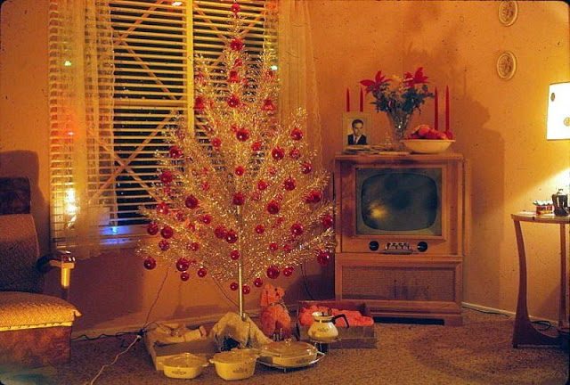 An aluminum tree decked with baubles a single color. Sleek and modern in the 50s-60s.
