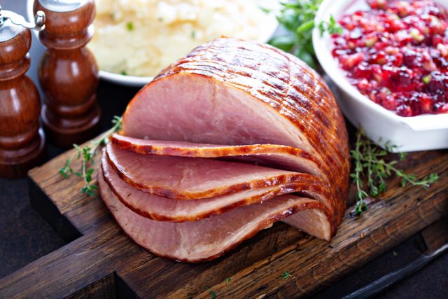 Holiday glazed sliced ham on the dinner table for Christmas.