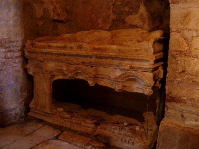 Photograph of the desecrated sarcophagus in the St. Nicholas Church, Demre, where Saint Nicholas’s bones were kept before they were removed and taken to Bari in 1087. Photo by Sjoehest CC BY-SA 3.0