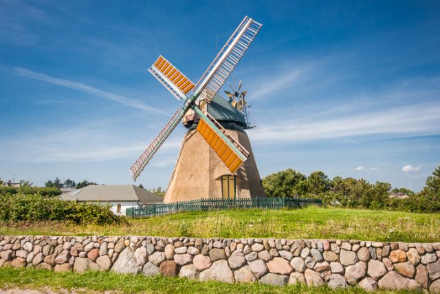 Traditional windmill in beautiful scenery on a sunny day in summer.