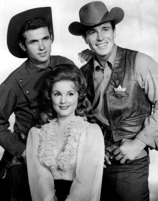 Cast photo from the television program Johnny Ringo. Pictured are Mark Goddard (Deputy Cully), Don Durant (Johnny Ringo) and Karen Sharpe (Laura Thomas).