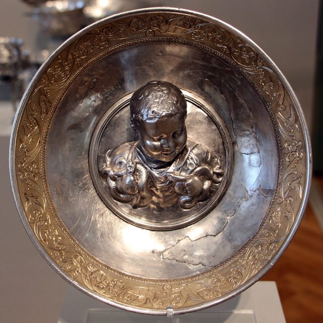 A Roman gilded silver bowl depicting the boy Hercules strangling two serpents, from the Hildesheim Treasure, 1st century AD, Altes Museum. Photo by Sailko CC BY 3.0