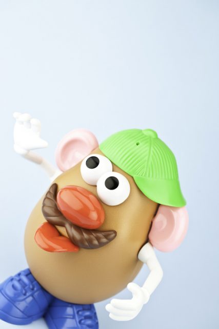 Suffolk, Virginia, USA – April 30, 2011: A vertical studio shot of the children’s toy, Mr Potato Head. Here Mr. Potato Head is wearing a cap and sticking out his tongue. Mr. Potato Head is made by the toy company Hasbro.