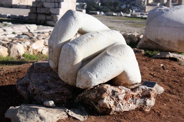 Hand in front of Hercules temple at Citadel Hill in Amman in Jordan, Middle East.