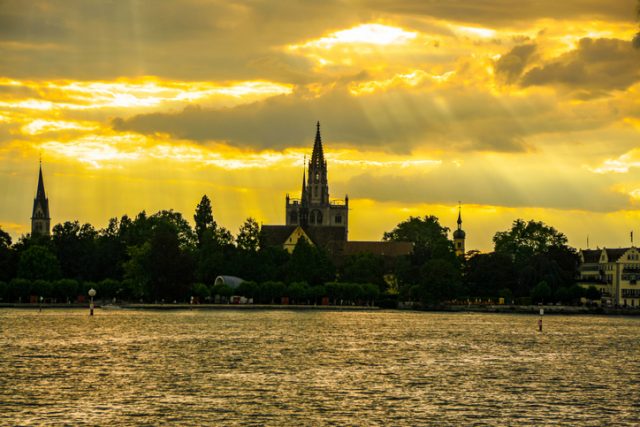 Scenic sunset and view of the old town of Konstanz on Lake Constance, with the cathedral in the center of the image. Bodensee, Germany.