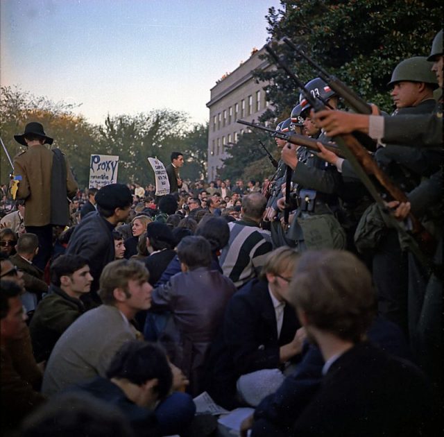 Military police keep back Vietnam War protesters during their sit-in on October 21, 1967, at the mall entrance to the Pentagon.