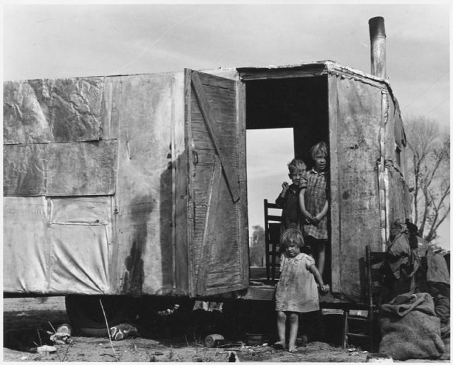 A migratory family from Texas living in a trailer in an Arizona cotton field