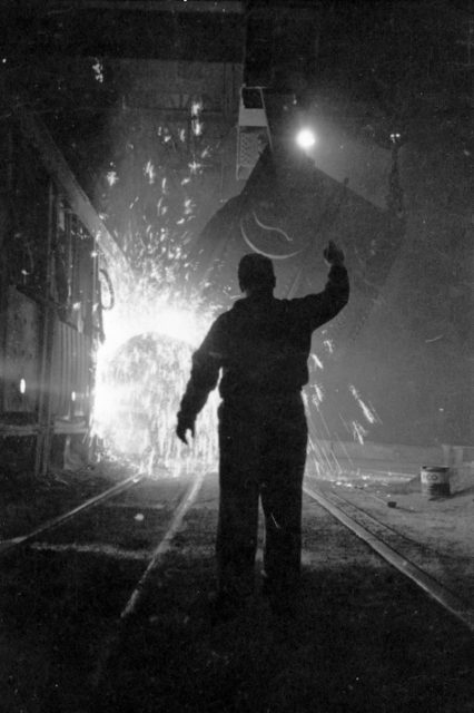 Steel worker in mill as molten steel spills from vat, in Chicago, Illinois, 1949. Image from Look photographic assignment ‘Chicago City of Contrasts’ by S. Kubrick.