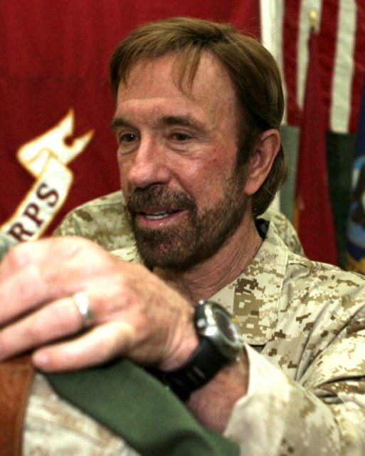 Martial arts expert and action film star Chuck Norris signs a T-shirt for Corporal William P. Kessler, 23 of Cedar Park, Texas. Kessler, a reconnaissance Marine with Company A, 3rd Reconnaissance Battalion from Okinawa, Japan