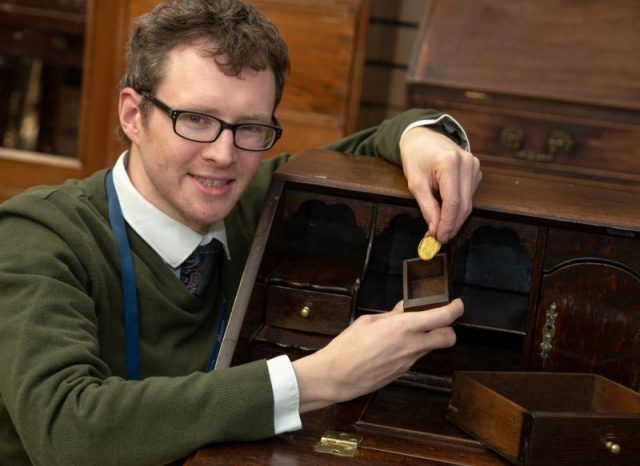 Edward Rycrodt with the coin and the tiny drawer he found it in. Photo courtesy of Hansons Auctioneers