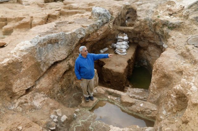 Yaakov Billing an archaeologist with the Israel Antiquities Authority (IAA) shows a large ritual bath (miqveh) at the site of the remains of a Jewish village from the Hasmonean period. Photo by MENAHEM KAHANA / AFP Getty Images
