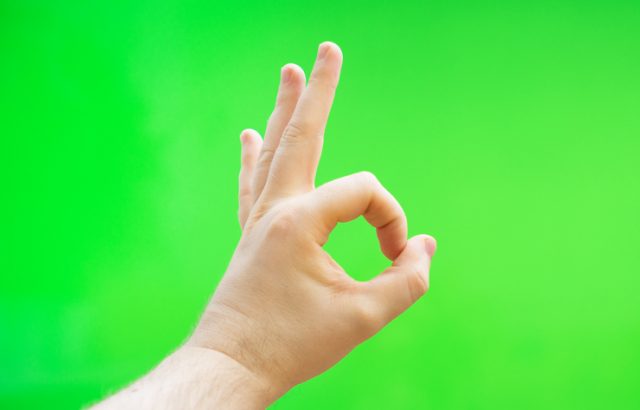 Male hand shows ok gesture.