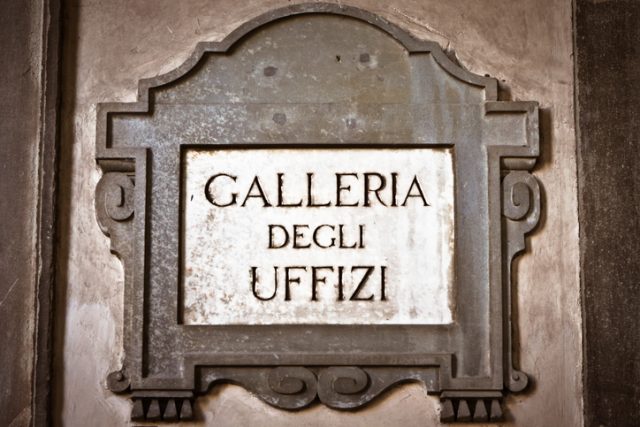 The original stone sign of the Galleria degli Uffizi in the famous exterior corridor of Florence (Tuscany, Italy).