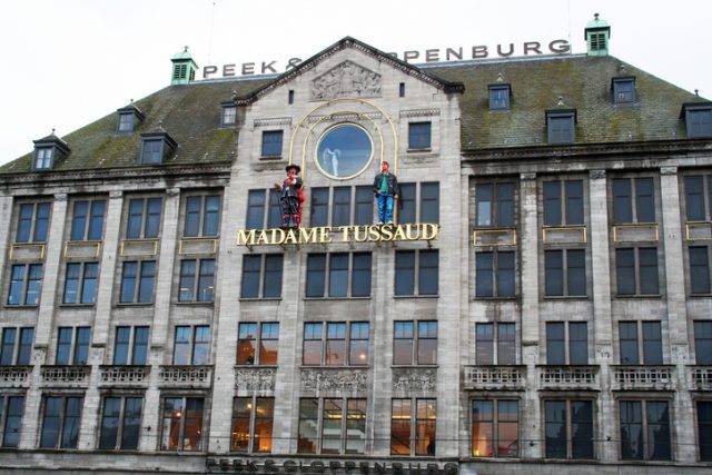 Amsterdam, Netherlands – March 26, 2009: The Madame Tussauds wax museum on Dam Square, located in the Peek & Clopenburg building. The museum is a popular tourist attraction in Amsterdam, housing the likenesses of famous people from around the world.