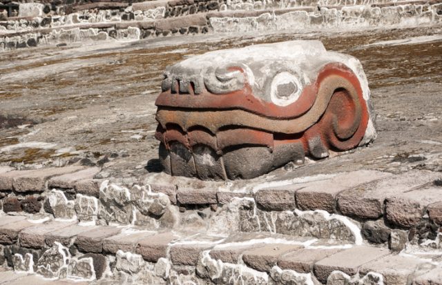 The Serpiente Emplumada (feathered serpent), dedicated to the god Quetzalcoatl, guarding the entrance to the ruins of the Aztec main temple, the Templo Mayor