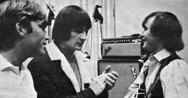 Photo of producer Terry Melcher (left) in the recording studio with the Byrds, Gene Clark (center) and David Crosby (right), listening to a take.