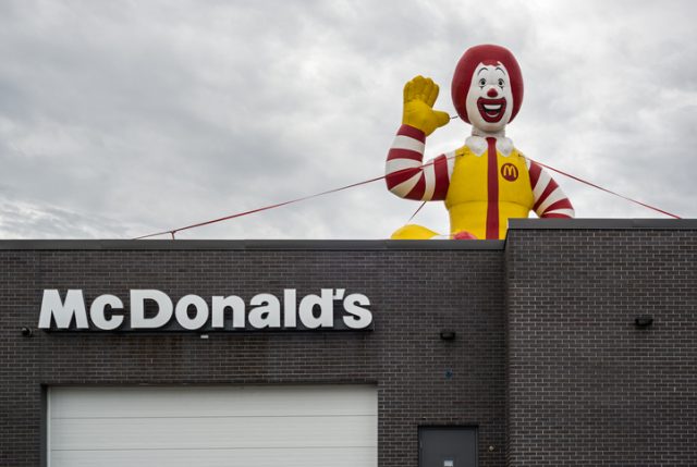 Huge inflatable Ronald McDonald sits atop a McDonald’s fast food restaurant
