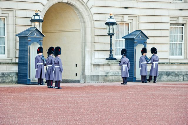 Shift change of the Queens Guard guarding gate to Buckingham Palace. They protect royal residences in London and the whole monarchs family.