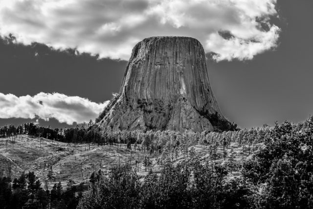 A black and white depiction of devils tower