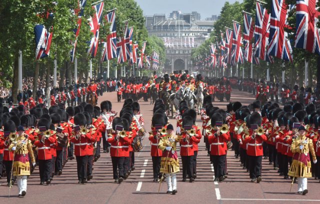 Guards and military bands march up the Mall in London in the Queen’s annual birthday parade of Trooping the Colour
