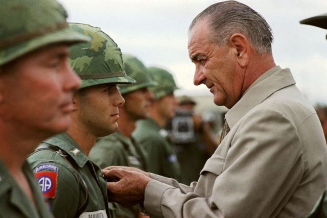 President Lyndon B. Johnson awards the Distinguished Service Cross to First Lieutenant Marty A. Hammer, in Vietnam.