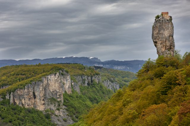 Monolithic limestone natural rock formation known as Katskhi Pillar with a monk’s cell on the top, in Georgia.