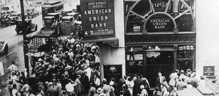 a crowd standing in front of a bank during the great depression