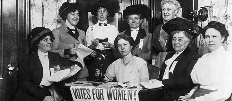 women gathered around a table to vote in early 1920s