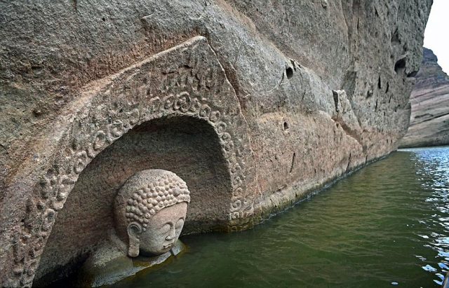 The statue is around 12. 5 feet (3. 8 meters) tall and carved into a cliff. Credit: cnn
