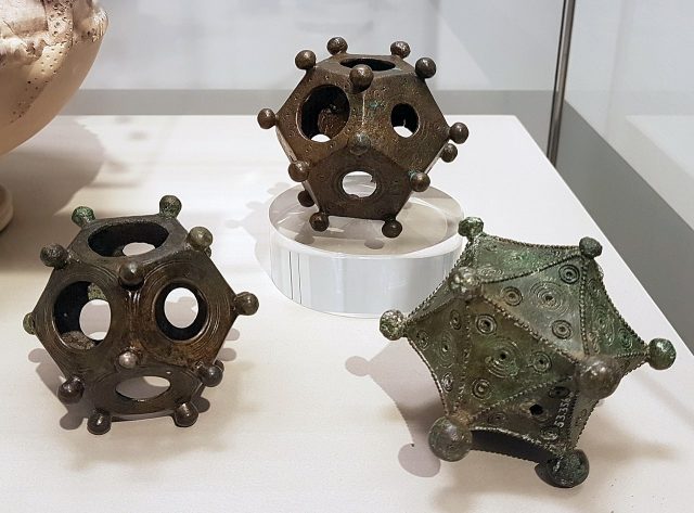 Two dodecahedra and an icosahedron on display in the Rheinisches Landesmuseum (Bonn, Germany). Kleon3 – CC BY-SA 4.0