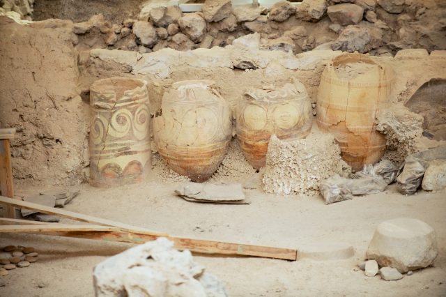 Ruins of the ancient buildings and decorated pottery from the Minoan Bronze Age at the archaeological site in Akrotiri, Greece.