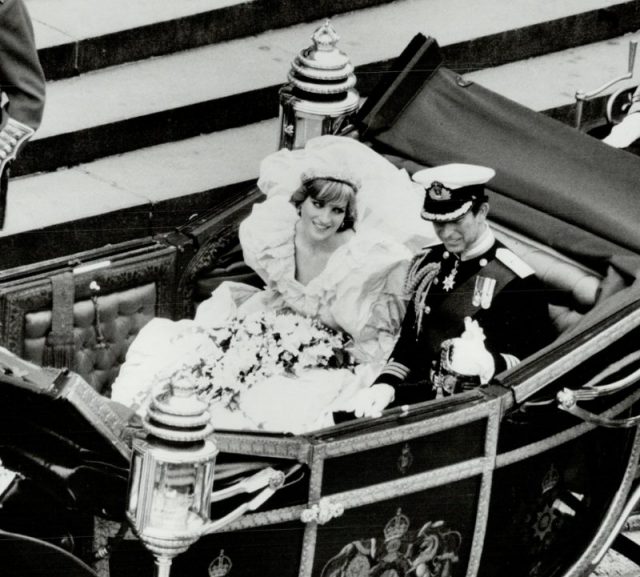 Princess Diana and Prince Charles at their wedding. Princess Diana's wedding dress somehow fit in that carriage.