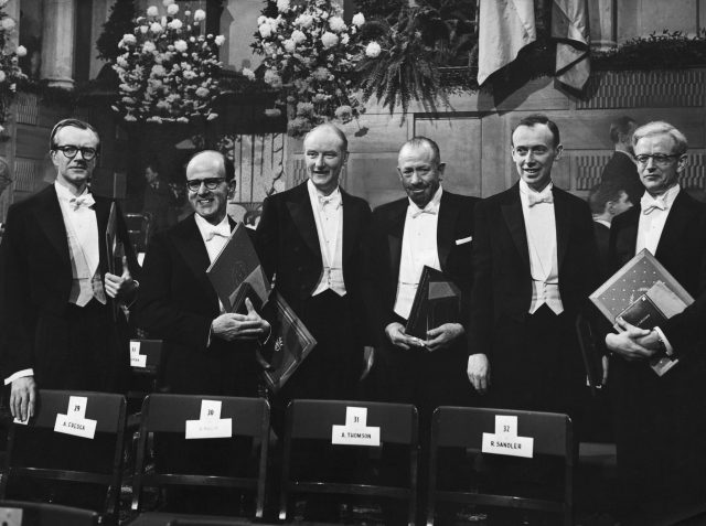 Professor Maurice Wilkins, Dr. Max Perutz, Prof. Francis Crick, John Steinbeck, Dr. James Watson, and Dr. John Kendrew posing with their Nobel awards after the distribution when they received them.