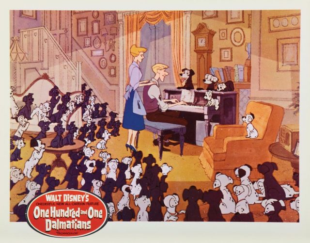 The One Hundred and One Dalmatians sitting around Roger at the piano 