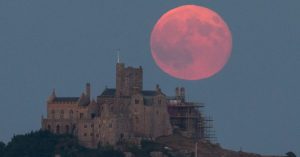 A strawberry moon rises behind St Michael's Mount in Marazion near Penzance on June 28, 2018 in Cornwall, England.