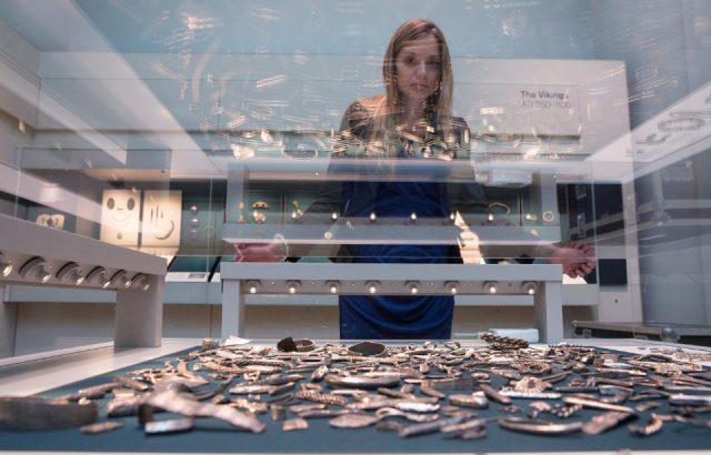 A woman views historic artifacts on display from the 'Cuerdale Hoard' in the new gallery 'Sutton Hoo and Europe AD 300-1100' in the British Museum on March 25, 2014 in London, England