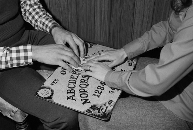 two people using a ouija board