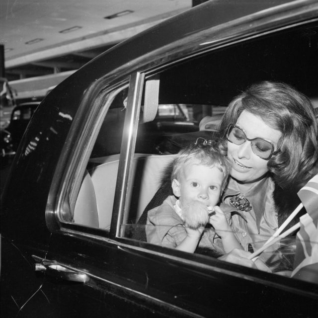Loren pictured here at the London Airport with her youngest son Edoardo, circa 1974. (Photo Credit: R. Brigden/ Getty Images)