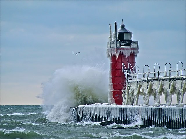 Waves crashing into the South Pier Lighthouse in South Haven during the winter