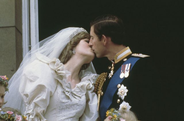 Charles and Diana kissing in their wedding attire