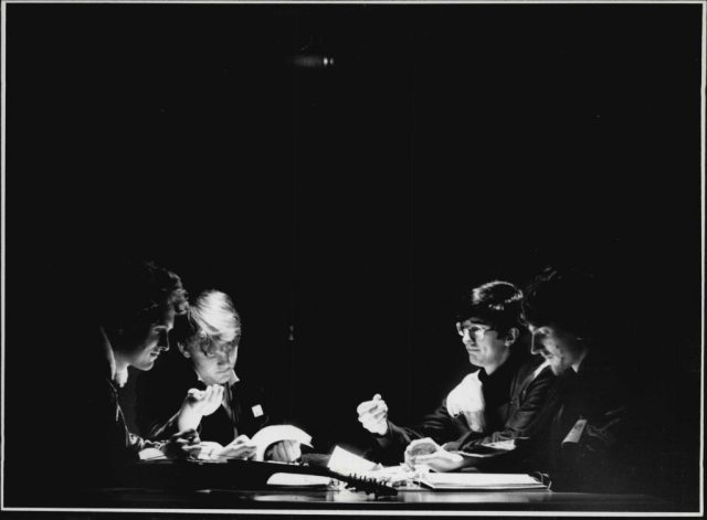 Four teenage boys playing dungeons & dragons at a table