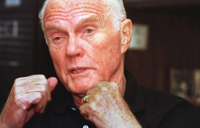 John Glenn holds up his fists during an interview prior to his trip to space at age 77.