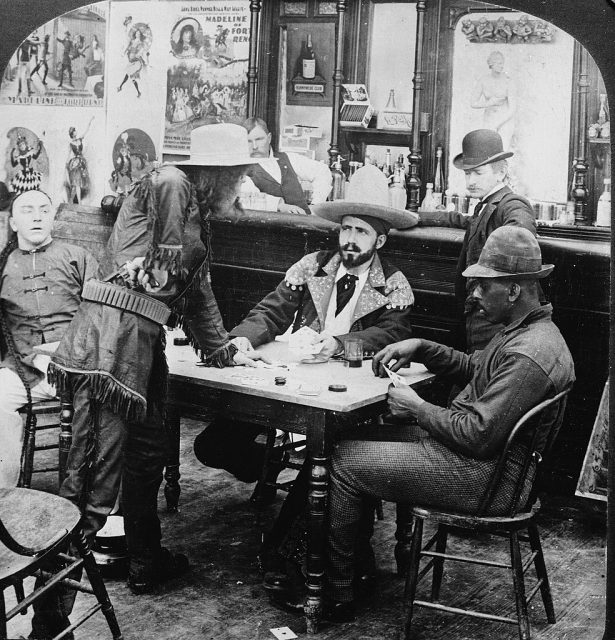 Two men in a gambling dispute as others look on