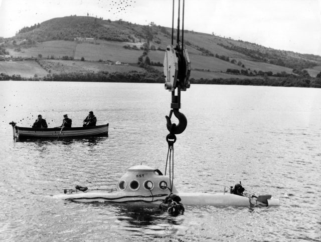 A submarine is lowered into Loch Ness to begin its search for the monster.