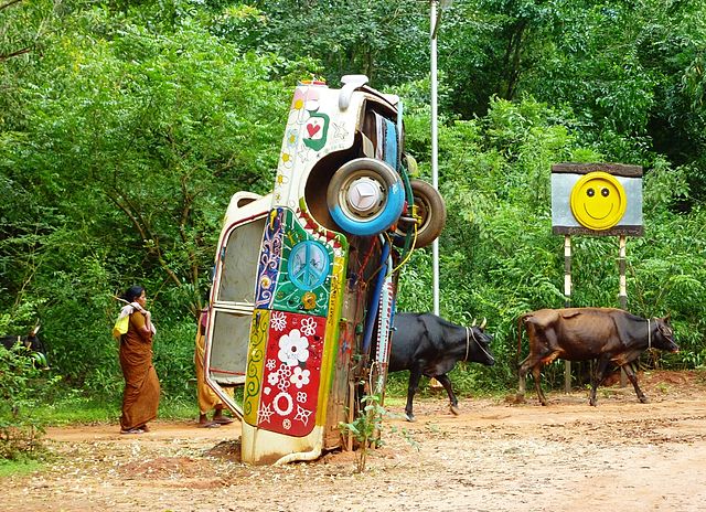 Upturned hippie car buried in the dirt