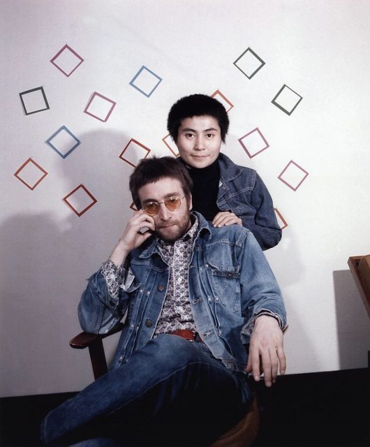 Yoko ono standing over john lennon's shoulder