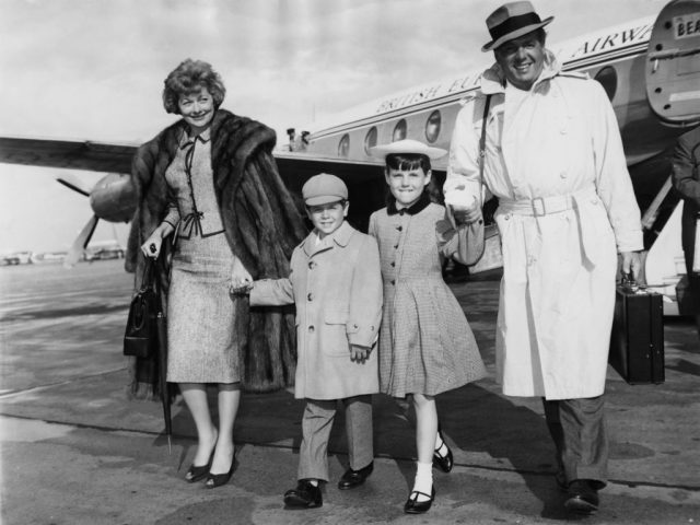 The four members of the Arnaz family walking away from a private airplane