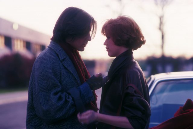 Judd nelson and molly ringwald standing together in the sunset